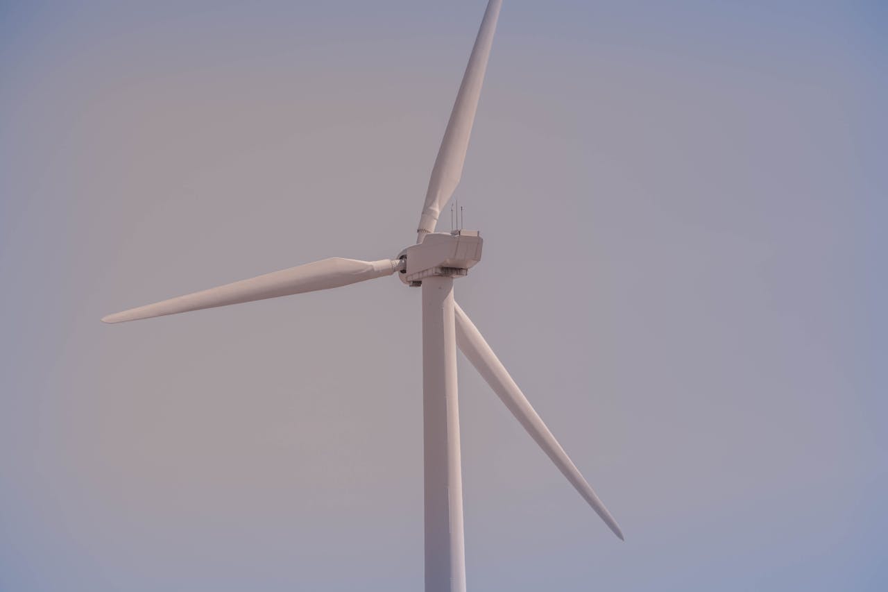 Close-up view of a wind turbine against a clear sky, symbolizing clean energy and sustainability.